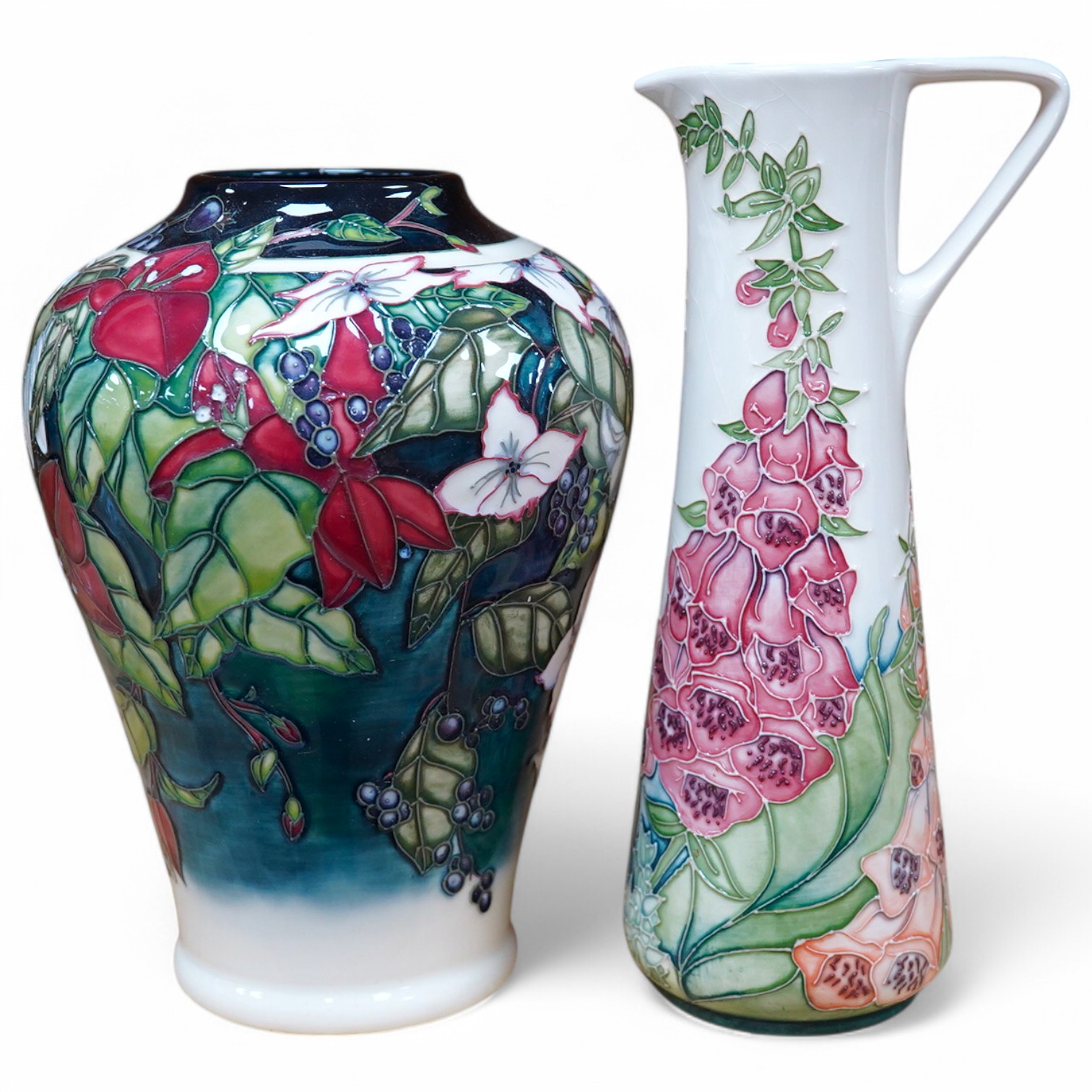 A Moorcroft ‘Nostalgia’ pattern vase together with a similar ‘Foxglove’ pattern ewer, 24.5cm. Condition - good, some crazing